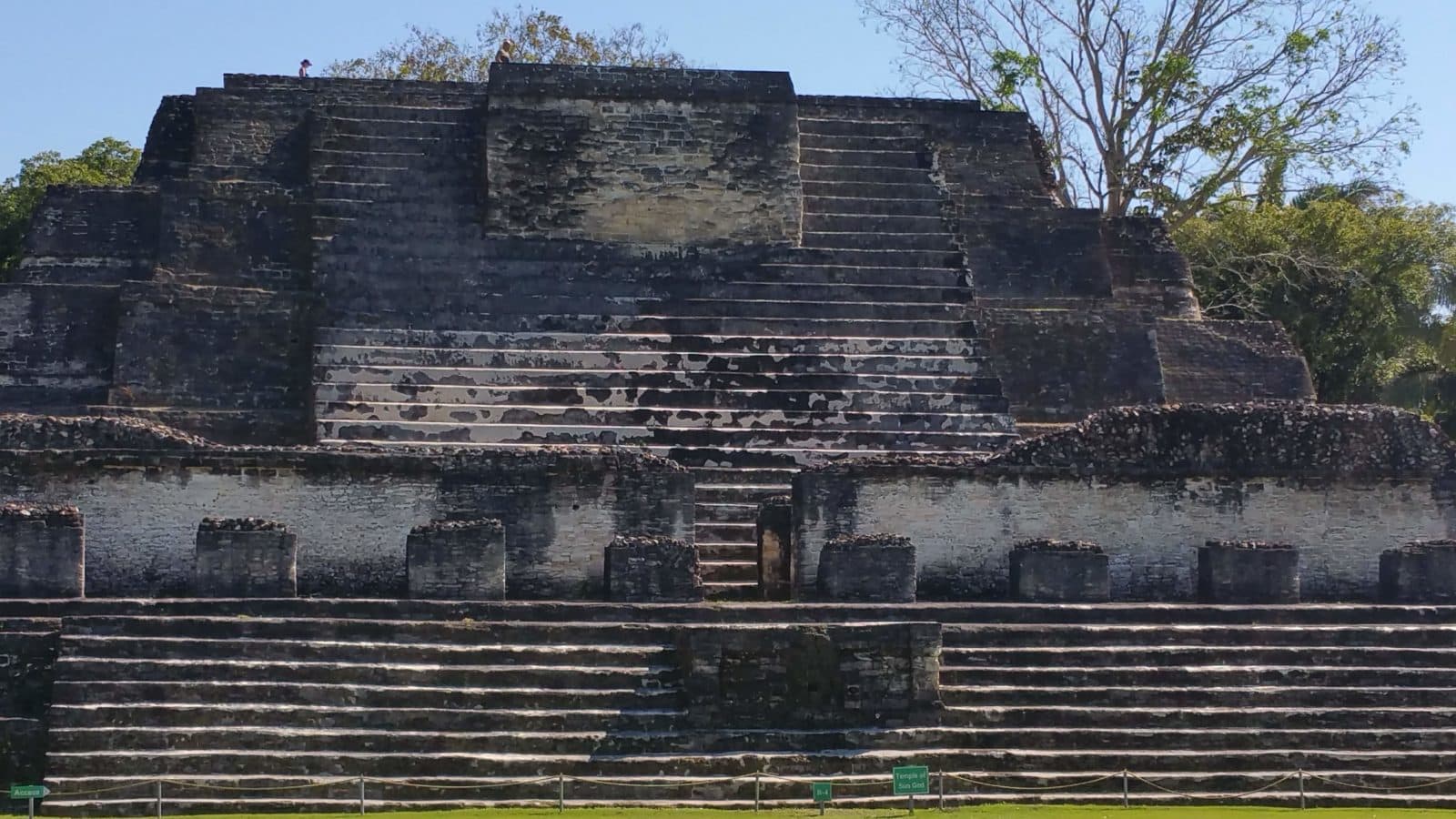 Gallivanting Souls family waves on top of Mayan structure at Altun Ha