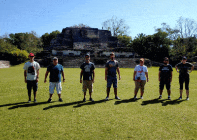 Family of adults jumps up and down in front of Mayan Ruins at Altun Ha. This is the Gallivanting Souls family and our family cruise that stopped in Belize.