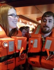 Couple demonstrates how to wear life jackets during Muster Drill Ruby Princess