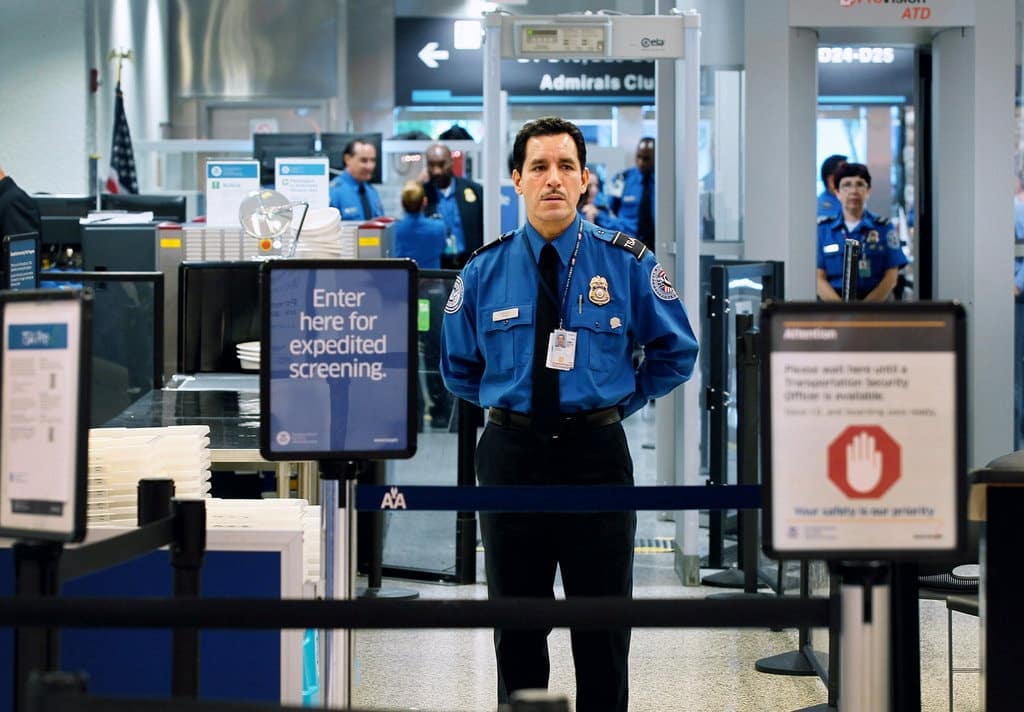 Customs officer stands in front of line