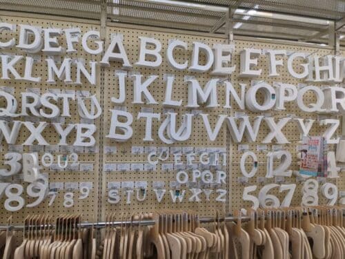white wooden letter on pegboard of Hobby Lobby to make your cruise travel sign