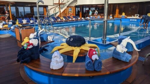 yellow octopus towel animal sits next to a red fish towel animal and a white elephant towel animalanimals take over the deck on Carnival Freedom