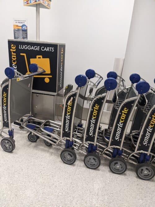 Airport luggage carts stacked together at the vending machine in airport