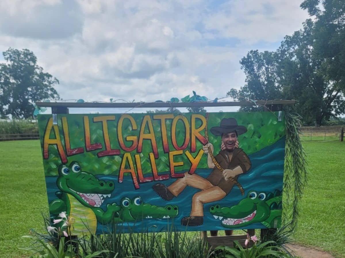 3 cartoon like alligators at the feet of an alligator wrangler man(Thank you RR for posing!