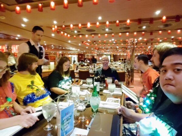 Family looks at menu in the Carnival main dining room