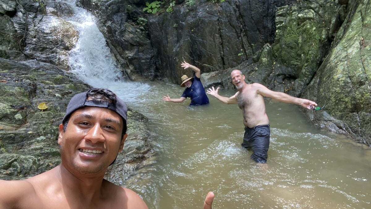 3 men act goofy at the Colomitos waterfall on a Navagante sailboat tour. One of these goofballs is Gallivanting Souls, Mike.