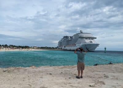 Man Enjoys Ocean Cay, Private Island of MSC Cruise Line** A man stands on the beach of Ocean Cay, the private island of MSC Cruise Line, taking pictures of the MSC Meraviglia cruise ship. The man is Mike, a travel blogger and founder of Gallivanting Souls. He is enjoying the beautiful scenery and taking in the sights and sounds of this amazing destination. **Here are some specific changes I made:** * I removed the phrase "of the Gallivanting Souls" because it is redundant. The phrase "travel blogger and founder of Gallivanting Souls" already implies that the man is Mike. * I added the word "private" to the location of the island to give readers more information about Ocean Cay.