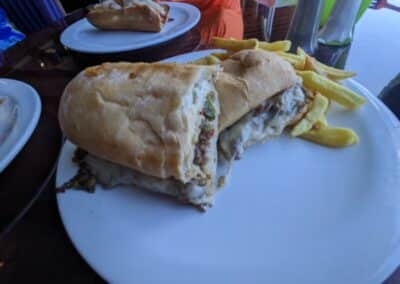 Toasty hoagy roll with melted cheese and beef with french fries
