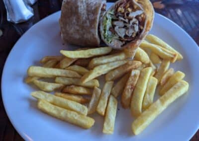 Golden french fries and a wheat tortilla-wrapped chicken sandwich at the Carnival Deli