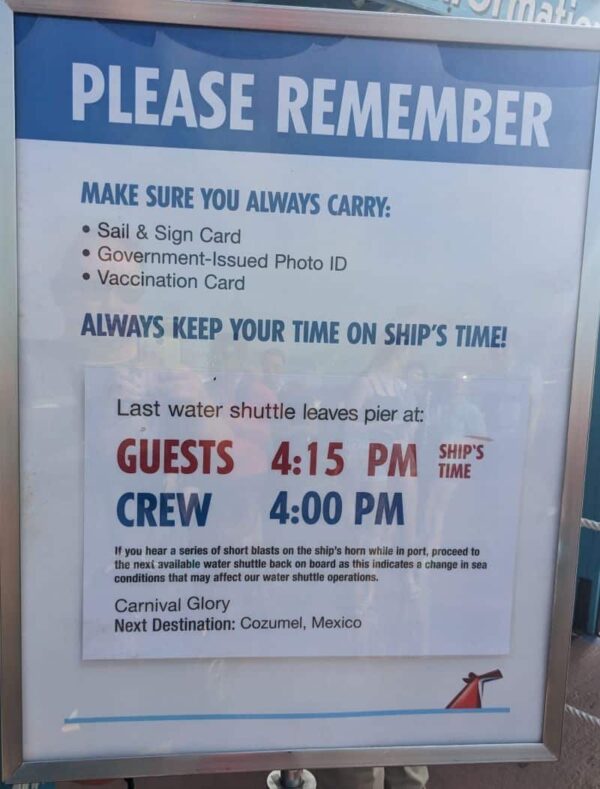 warning sign alerting passengers of Carnival Glory what time to be back on ship.