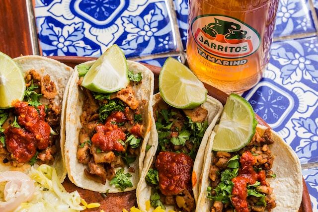 4 el pastor tacos and a juratos orange drink found in Los Angeles