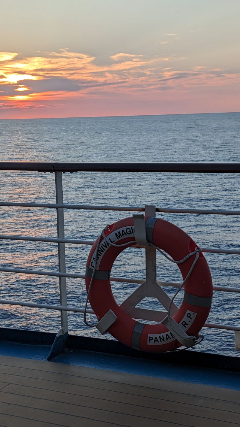 a beautiful orange sunset from the deck of Carnival Magic