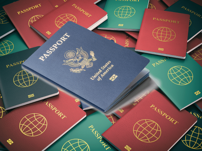 passports in red,blue,geen, and black lie on a table