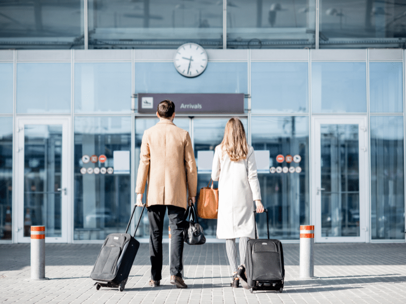 Couple at airport. Hopefully they have cross-packed incase one of their suitcases gets lost.