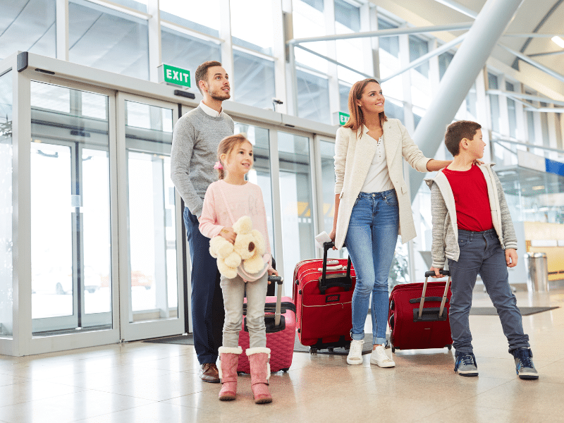 Family at airport ready to check in their suitcases. Did they crosspack to ensure some of their belongings arrive?