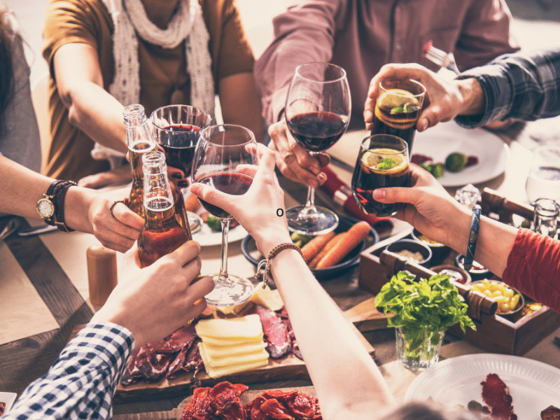 a group of cruisers toast to the evening in the main dining room on a cruise