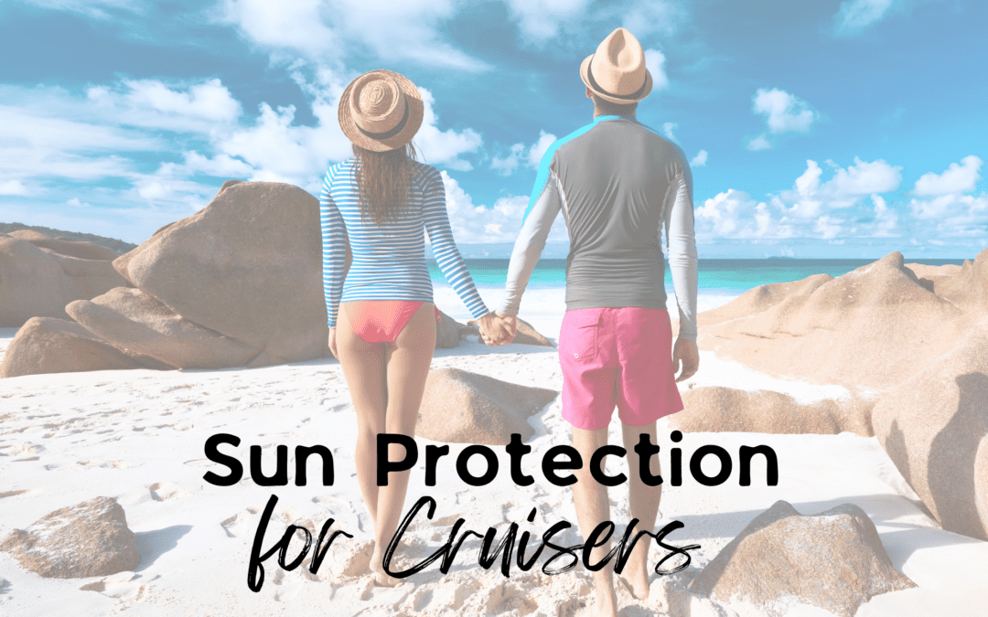 Man and woman wearing sun protective shirts walk on beach