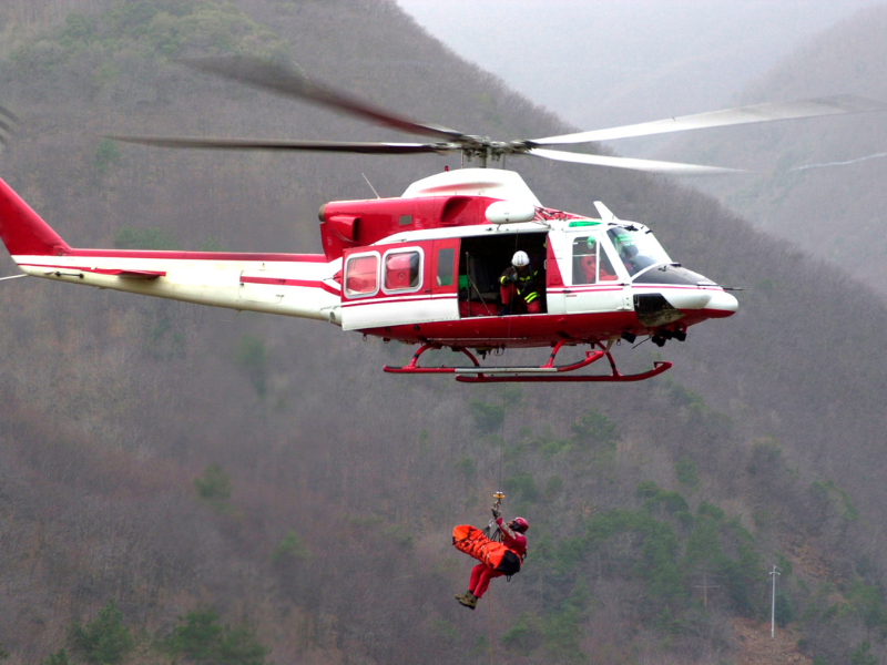 a helicopter prepares to evacuate a cruise passengre