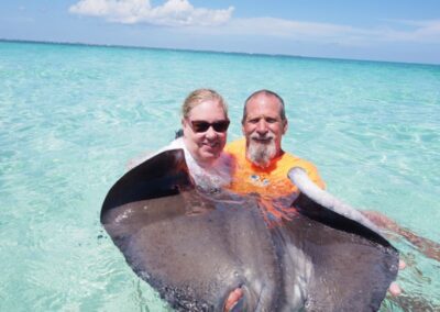 Mike and Kristina holding a stingray underwater during a Carnival cruise in the Caribbean.