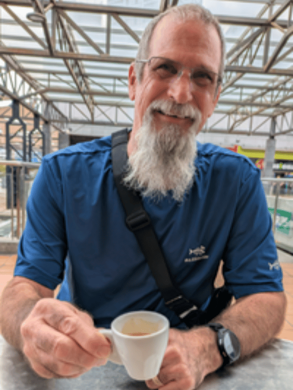 mike espresso 2 man in blue shirt holds a tiny cup of espresso in Montserrat,Spain