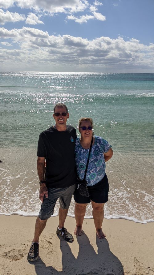 Man and woman stand on wild side beach in cozumel on a jeep tour