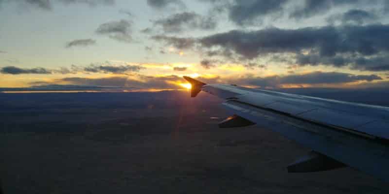 Looking out the window of airplane and seeing sunset