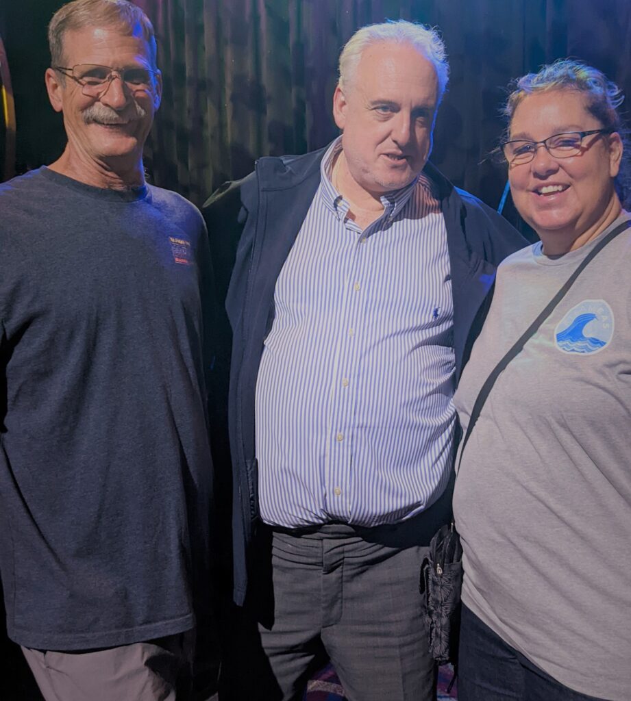 two men and one woman pose for picture at a For Fun's Sake gathering